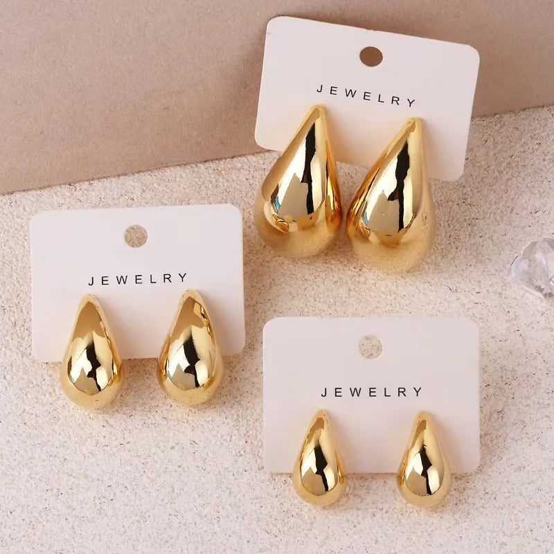 Golden teardrop-shaped earrings with a minimalist